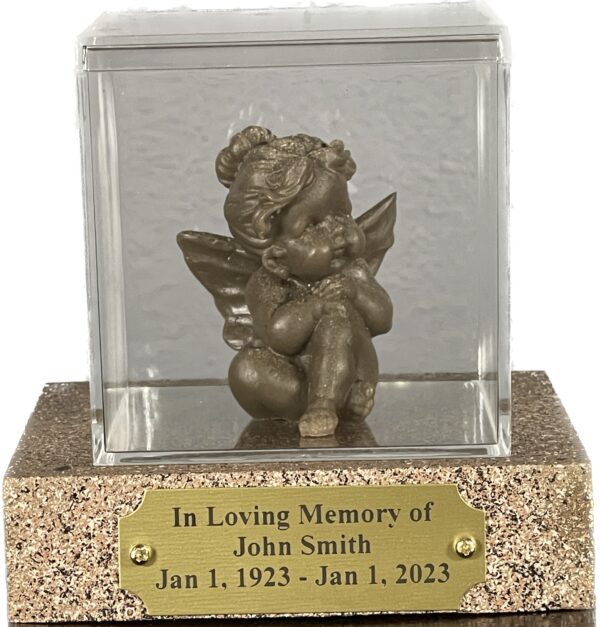 Seraph Angel Ashen Figurine resting on a wooden base, featuring an engraved plaque, with an acrylic glass dome covering it